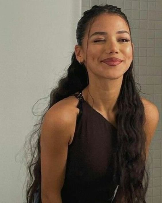 Winking woman with long wavy hair