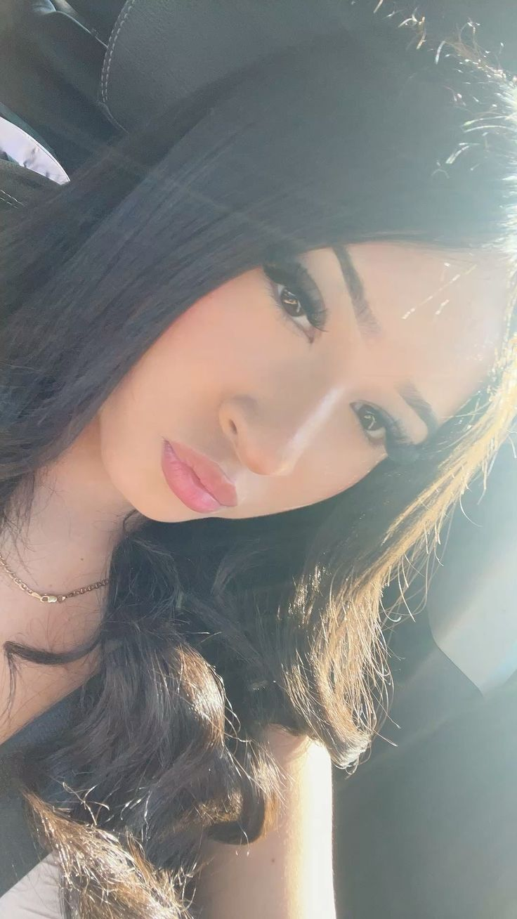Sunlit selfie of woman with dark hair
