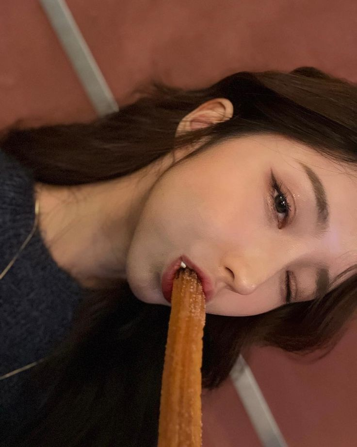 Close-up of woman eating a churro