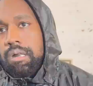 Close-up of Kanye West wearing a hooded jacket, looking to the side